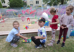 Dzieci malują farbami na rozciągnietej folii