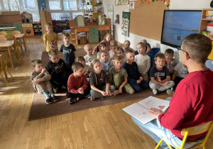 Dzieci siedzą na dywanie