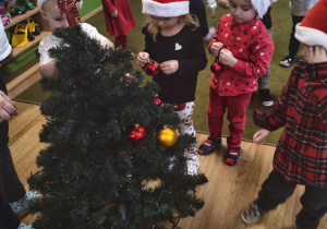 Dzieci z grupy I ubierają choinkę