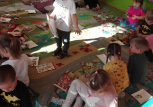 Przedszkolaki wycinają na dywanie przetwory mleczne z gazetek sklepowych