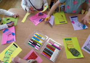 Dzieci z grupy IV ozdabiają papierowe skarpetki mazakowymi wzorami