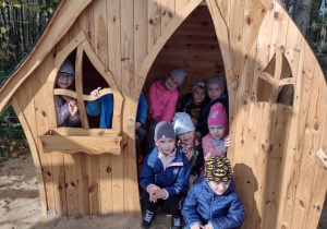 Przedszkolaki z grupy V bawią się w drewnianym domku