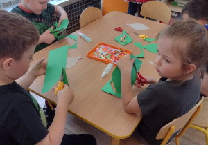Czworo dzieci wycina zielone listki