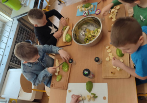 Chłopcy podczas krojenia awokado i bananów