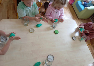 Przedszkolaki robią z plasteliny ogórki