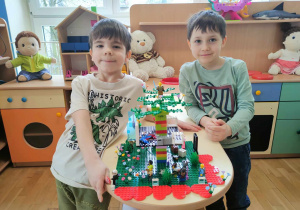 Dwóch chłopców ze zbudowanym domkiem na drzewie